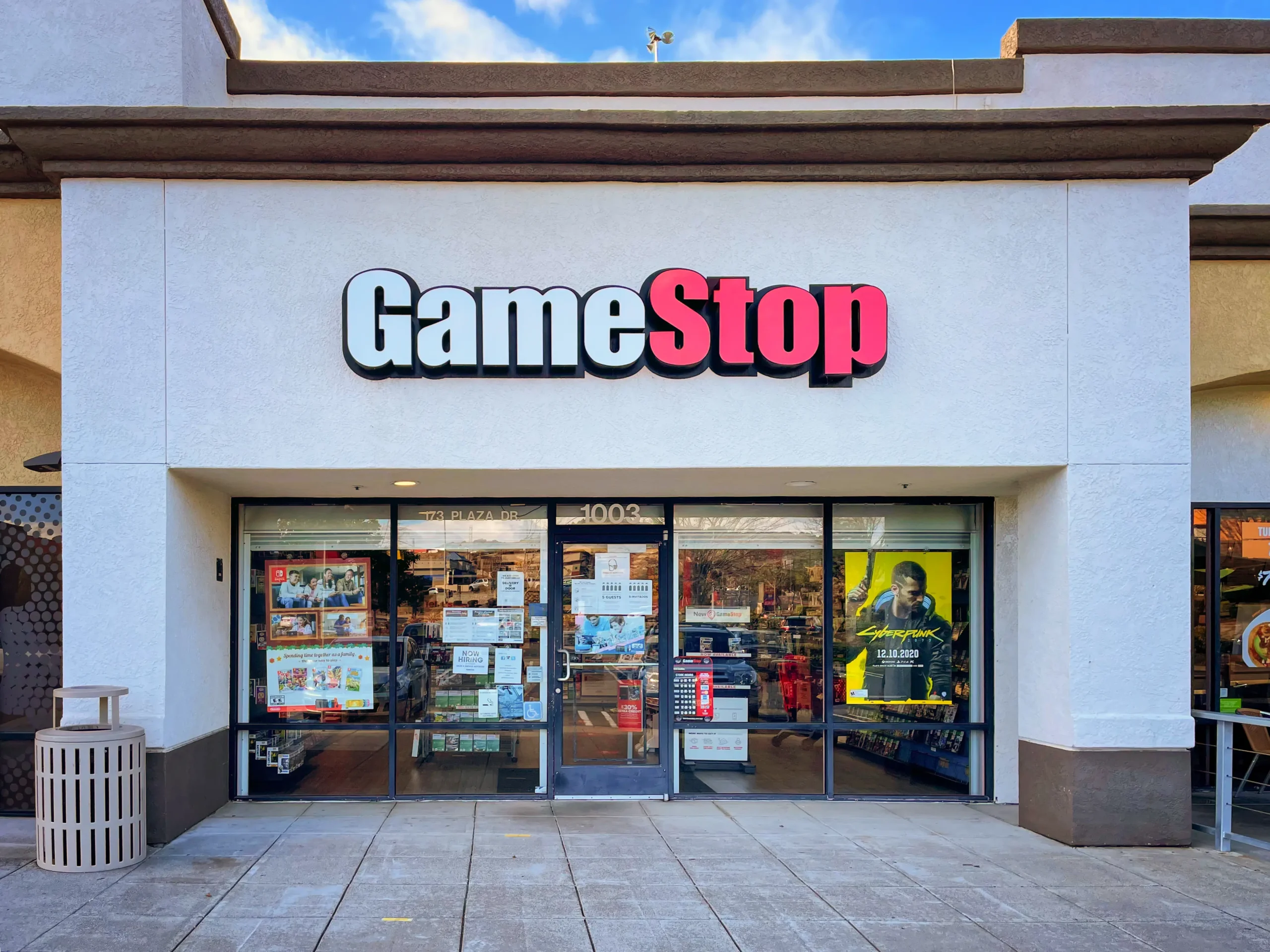 The front exterior of a GameStop retail store in Vallejo, California, with its white facade and prominent red and white logo.