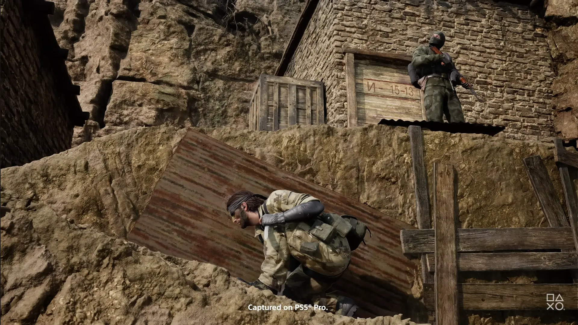 A stealth gameplay scene from Metal Gear Solid Delta: Snake Eater, showing Snake on a dirt slope below an enemy soldier.