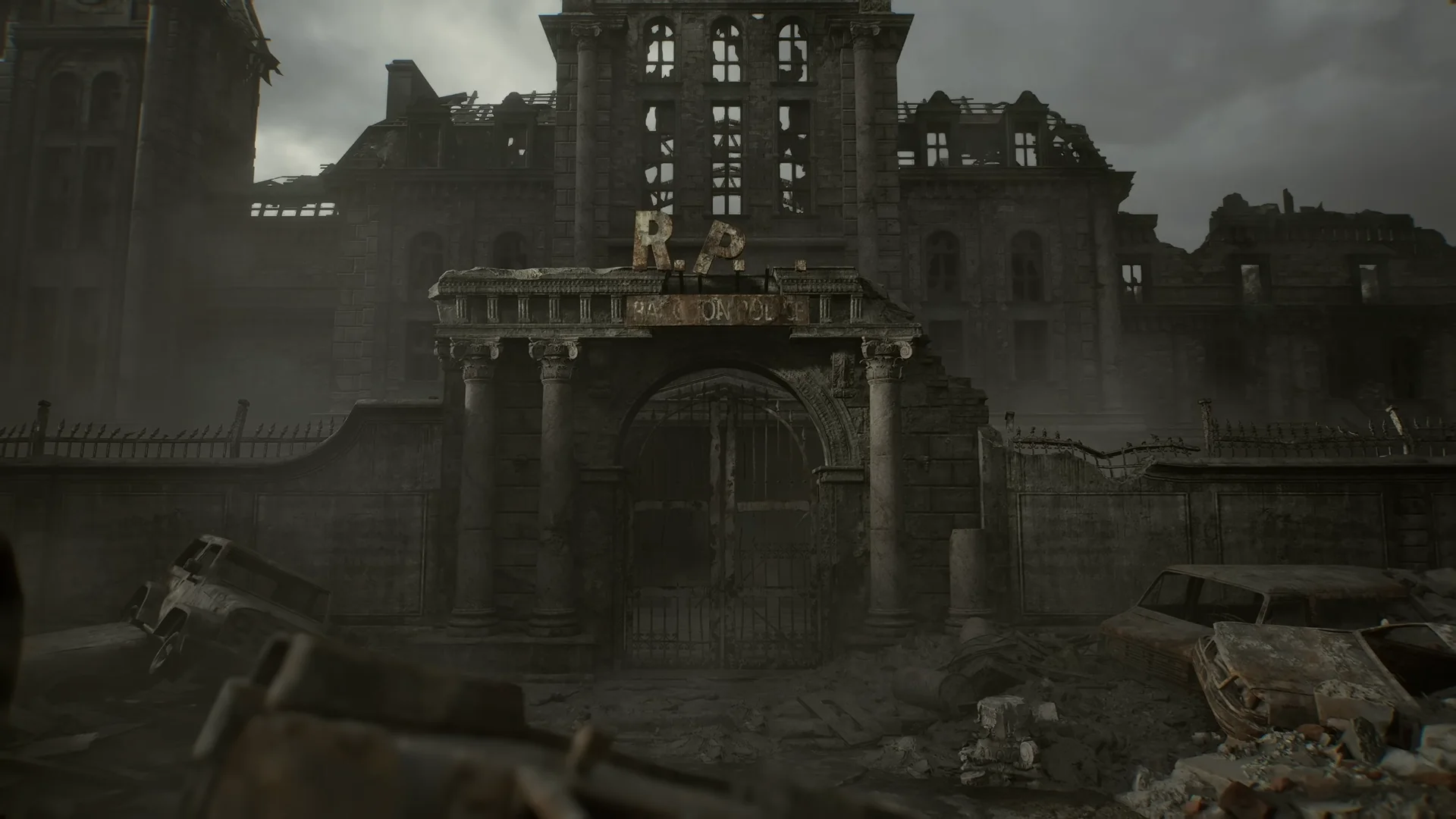 The heavily damaged exterior of the Raccoon City Police Department building from Resident Evil Requiem, with debris and ruined cars in the foreground.