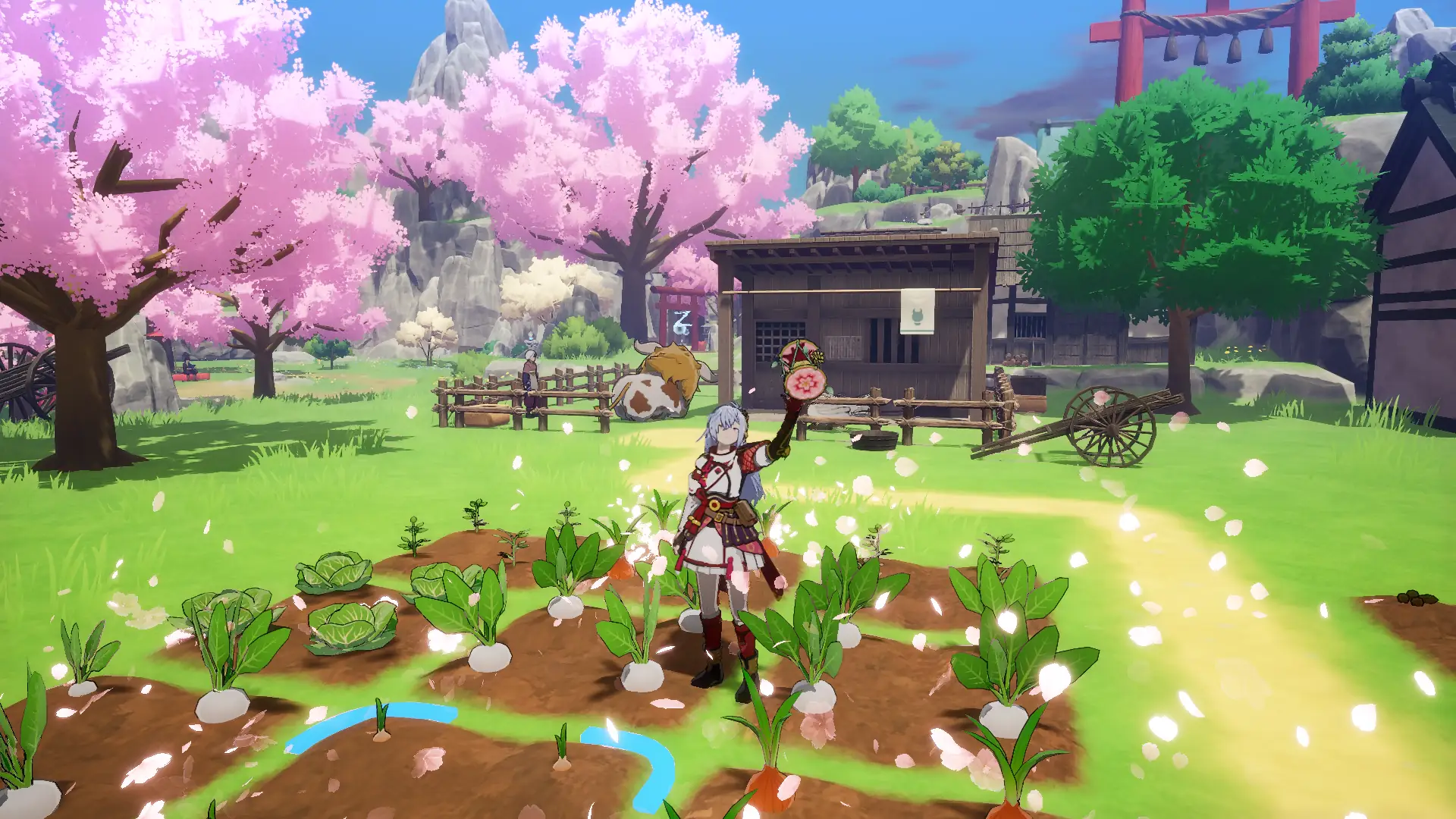 A colorful screenshot from Rune Factory: Guardians of Azuma showing the main character, a white-haired figure in red and white armor, standing in a vibrant green field. Around them are rows of turnips and carrots. In the background, there's a rustic wooden house, a brown cow, a character tending to crops, and large pink cherry blossom trees, all under a bright blue sky.