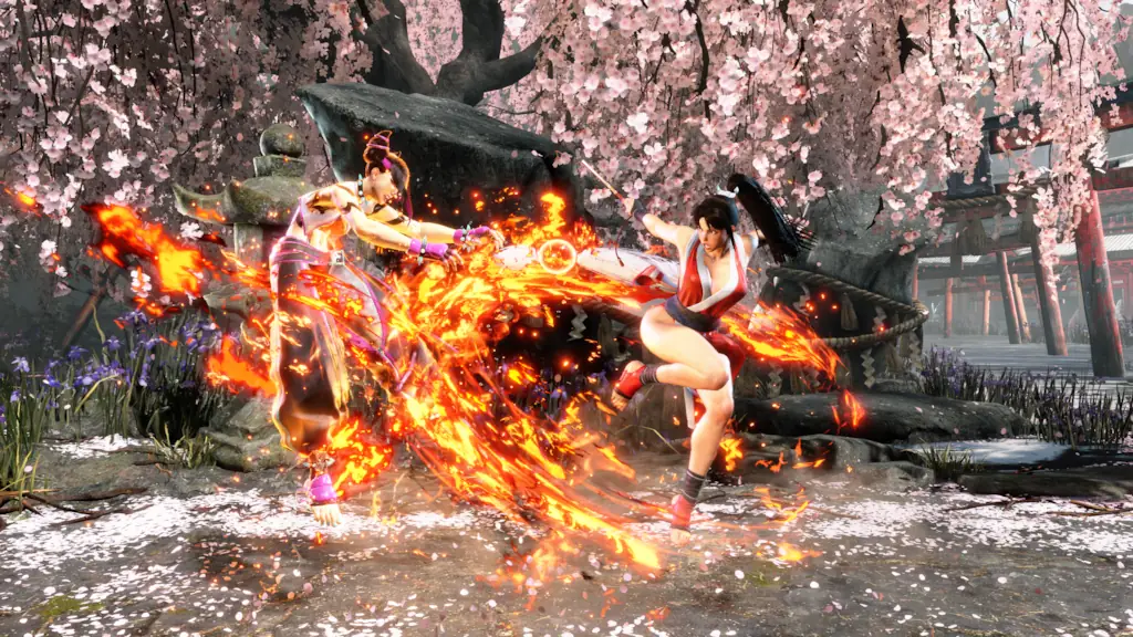 Mai Shiranui from Street Fighter 6 in combat, surrounded by fiery special effects, under cherry blossom trees.